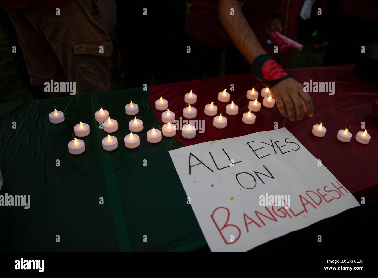 Washington DC, USA. 3rd Aug 2024. A sign with the text 'All Eyes on Bangladesh' is seen during the Bangladeshi community's candlelight vigil on August 03, 2024, in the National Mall, Washington DC, USA, to support the Anti-Discriminatory Students Movement in Bangladesh. In the vigil, participants condemned the government for killing innocent and underage students. They also demand to step down current prime minister Sheikh Hasina, who has been in power since 2009.  But later protests began in bloodshed, more than 250 people got killed Credit: Aashish Kiphayet/Alamy Live News Stock Photo