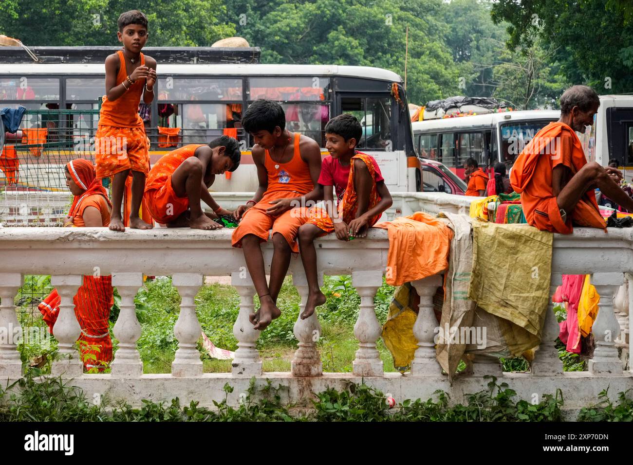Children of travelling devotees of Hindu God Shiva play while taking a ...