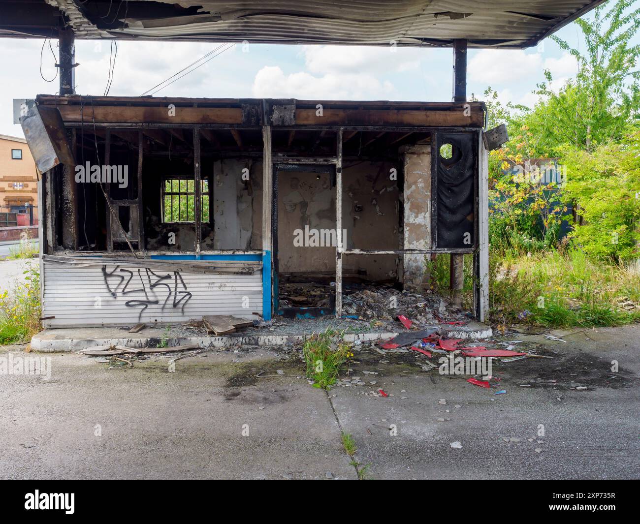 Abandoned building with graffiti and overgrown vegetation, showcasing the effects of time and neglect. Wigan UK. Stock Photo