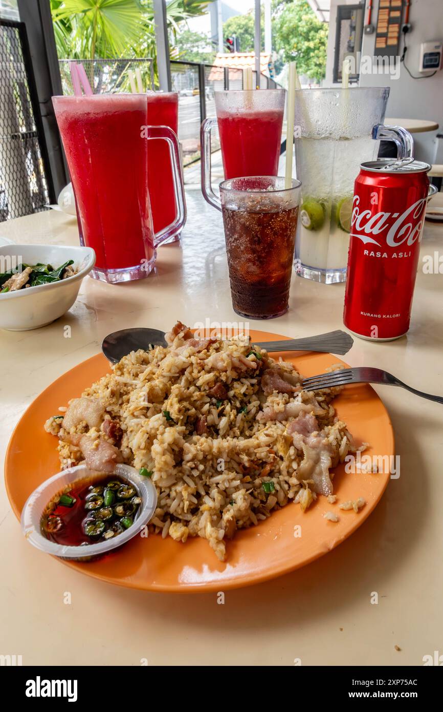 A plate of egg fried rice with coke and watermelon shakes at The Hillside Food Court in Penang, Malaysia. Stock Photo