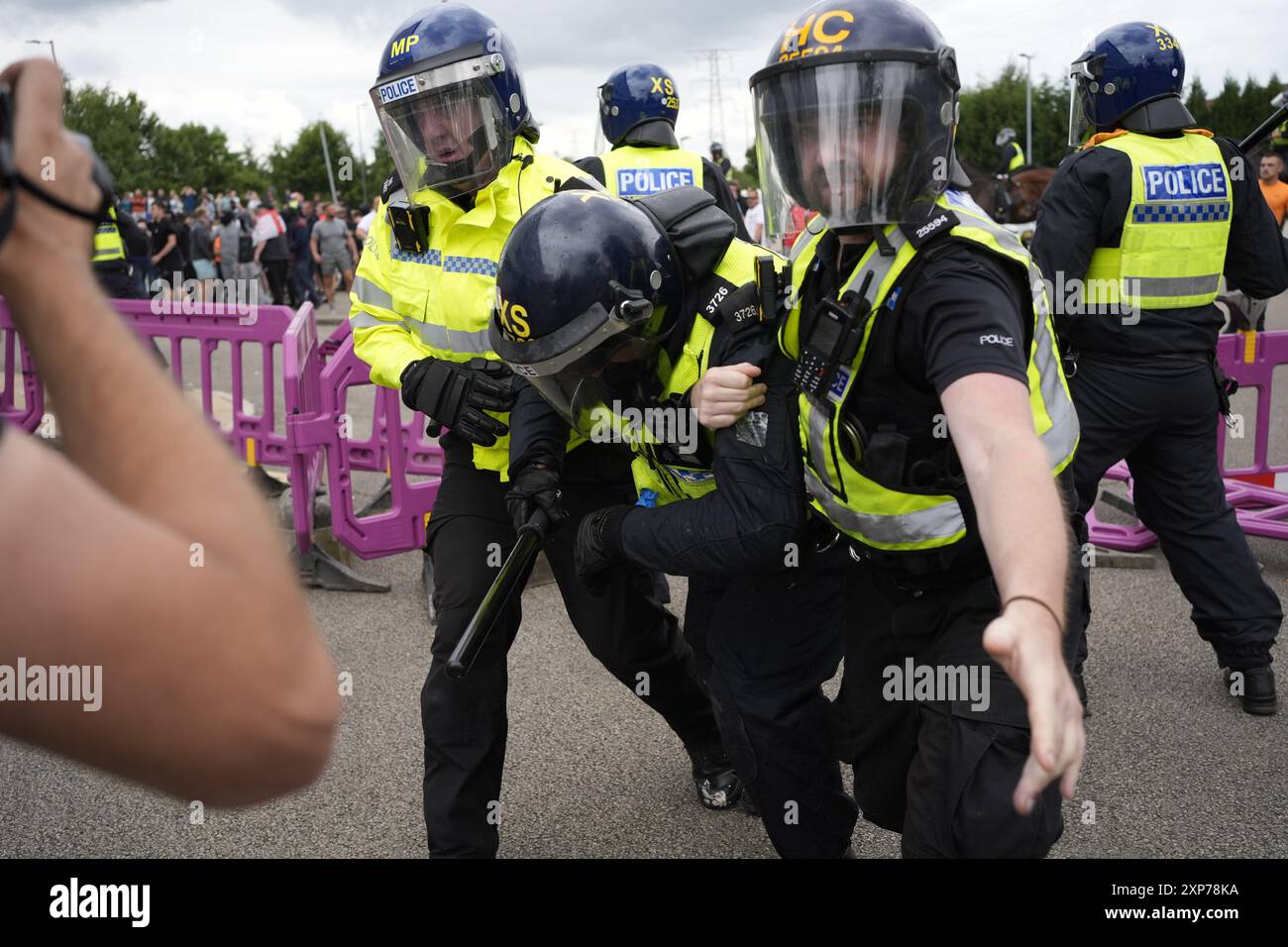 A police officer is injured as trouble flares during an anti-immigration protest outside the Holiday Inn Express in Rotherham, South Yorkshire. Picture date: Sunday August 4, 2024. Stock Photo