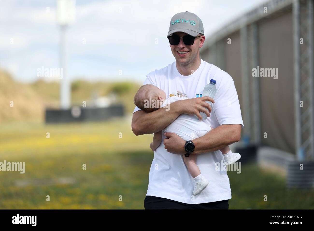 James Rutter, husband of Great Britain's Amber Rutter, poses with son ...