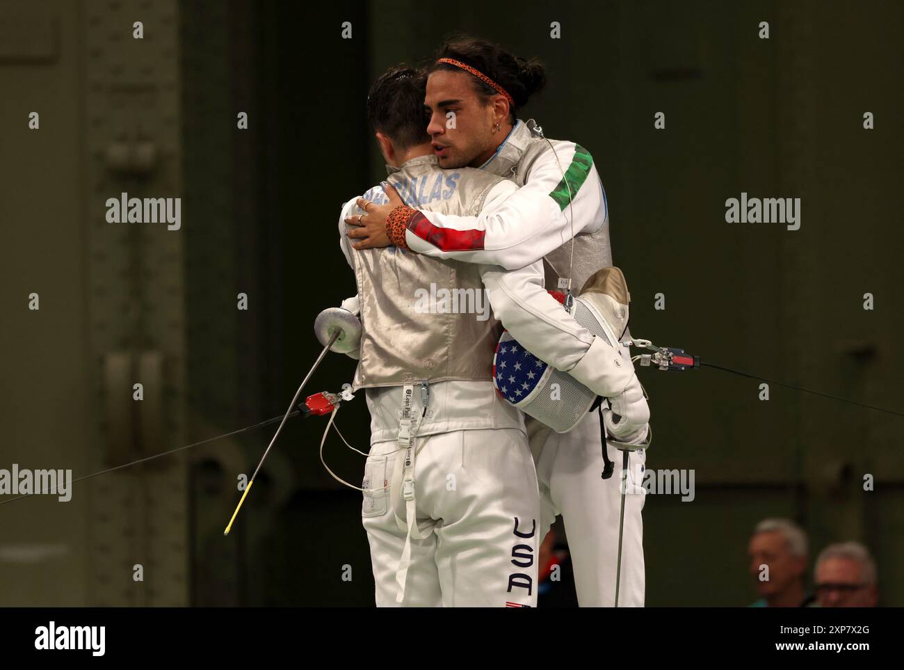 Paris, France. 4th Aug, 2024. Paris Olympics: Fencing. Men's Foil Team Semi Finals at Grand Palais - Blue Piste. Japan v France. Japan's Takahiro Shinkine (left) is hugged by France's Enzo Lefort after a win means victory for Japan during day nine of the Paris Olympic Games 2024, Paris, France. Credit: Adam Stoltman/Alamy Live News Stock Photo