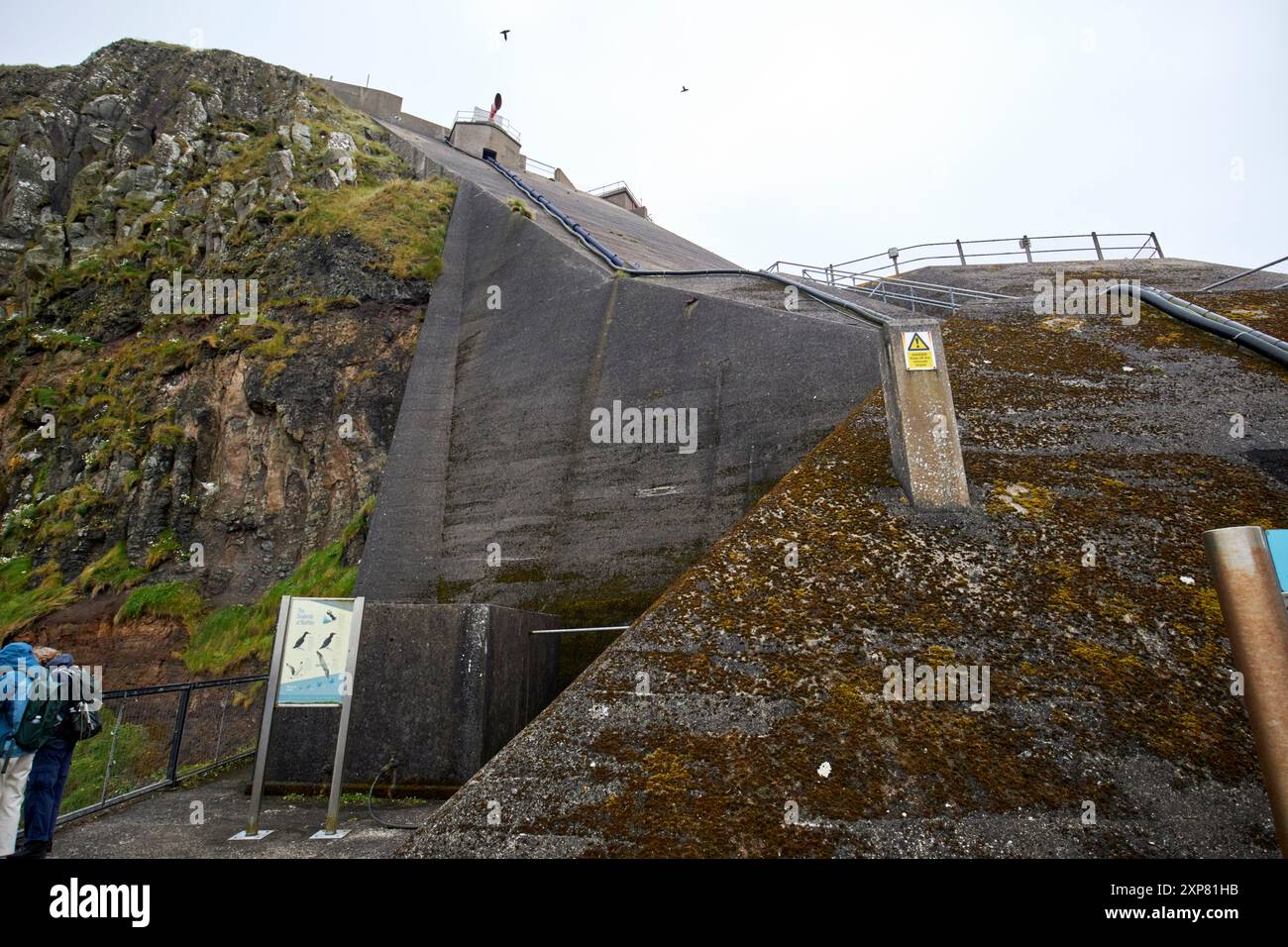 concrete wall all hand poured on side of the cliff to construct rathlin west light lighthouse rathlin island, county antrim, northern ireland, uk Stock Photo