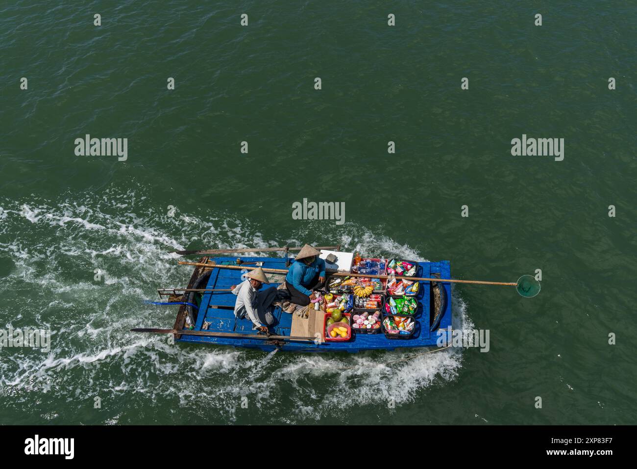 Culture Travel Vietnam UNESCO World Heritage Site Traders offer goods to ship tourists on Halong Bay Stock Photo