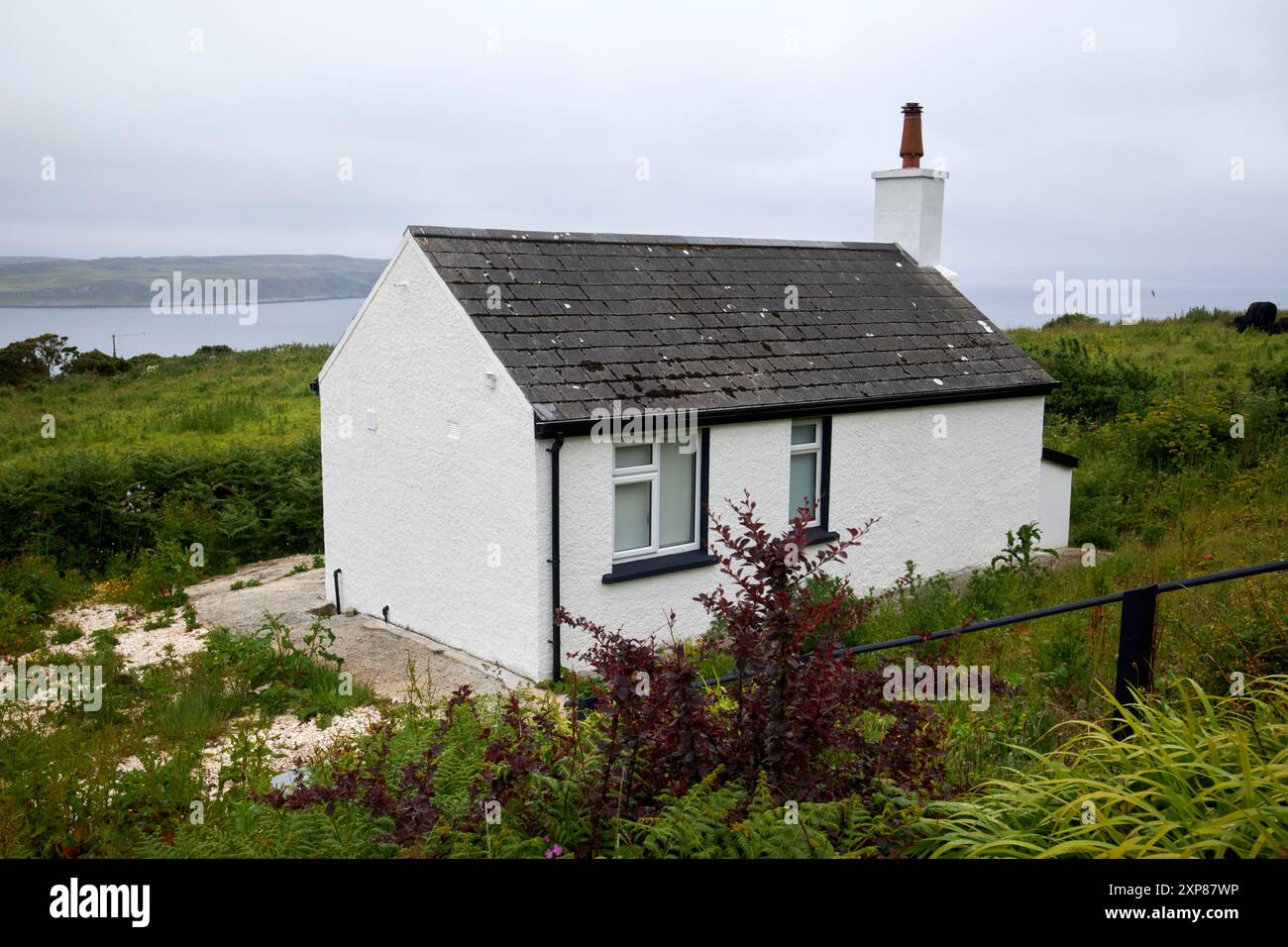 small traditional whitewashed stone cottage with tiled roof rathlin island, county antrim, northern ireland, uk Stock Photo