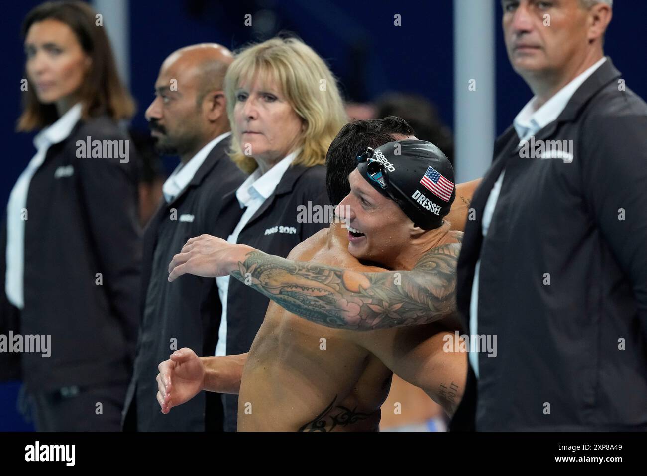 United States' Caeleb Dressel celebrates with a teammate winning the ...