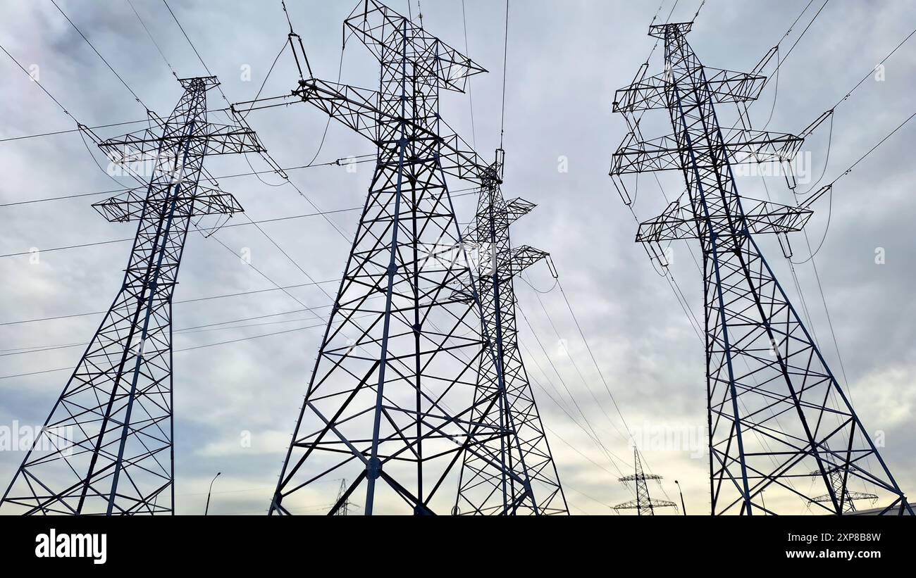 Several high voltage power lines against a dramatic cloudy sky Stock ...