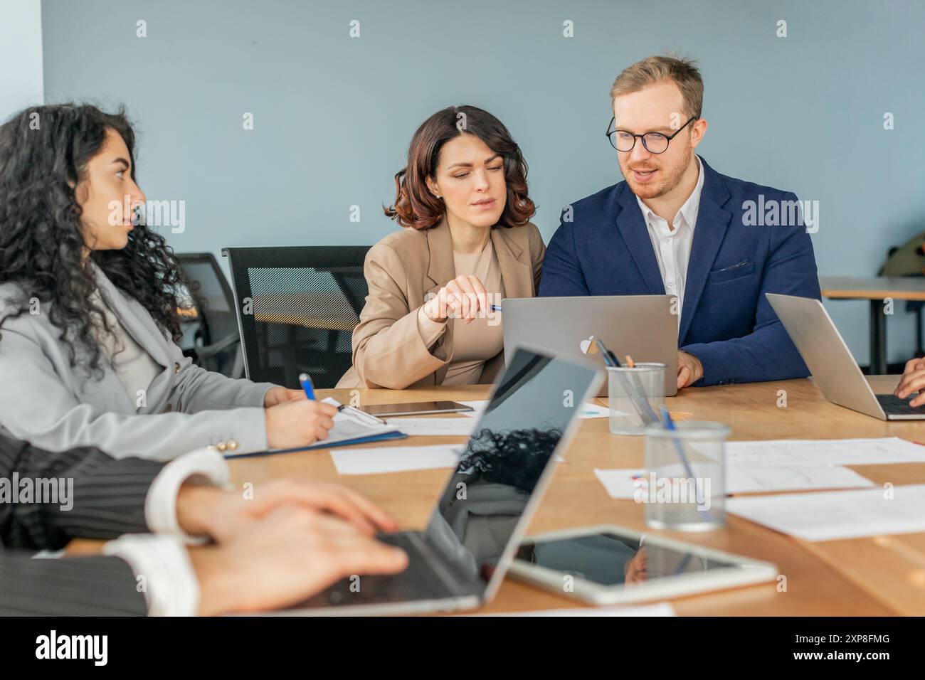Business Professionals Collaborate on a Project Using Laptops Stock Photo