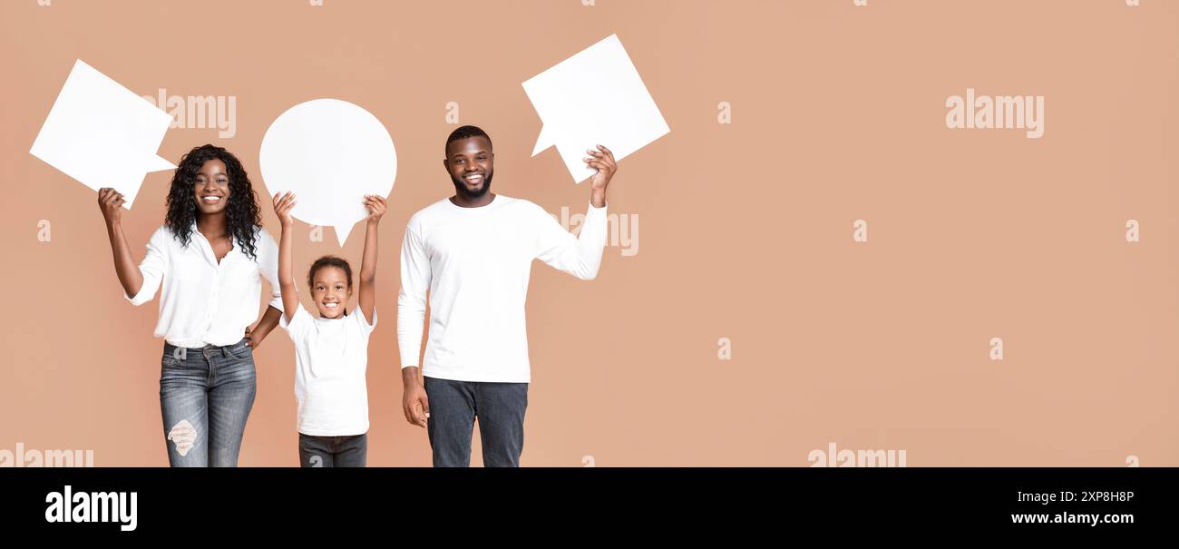 Empty speech bubbles in hands of smiling african american family Stock Photo