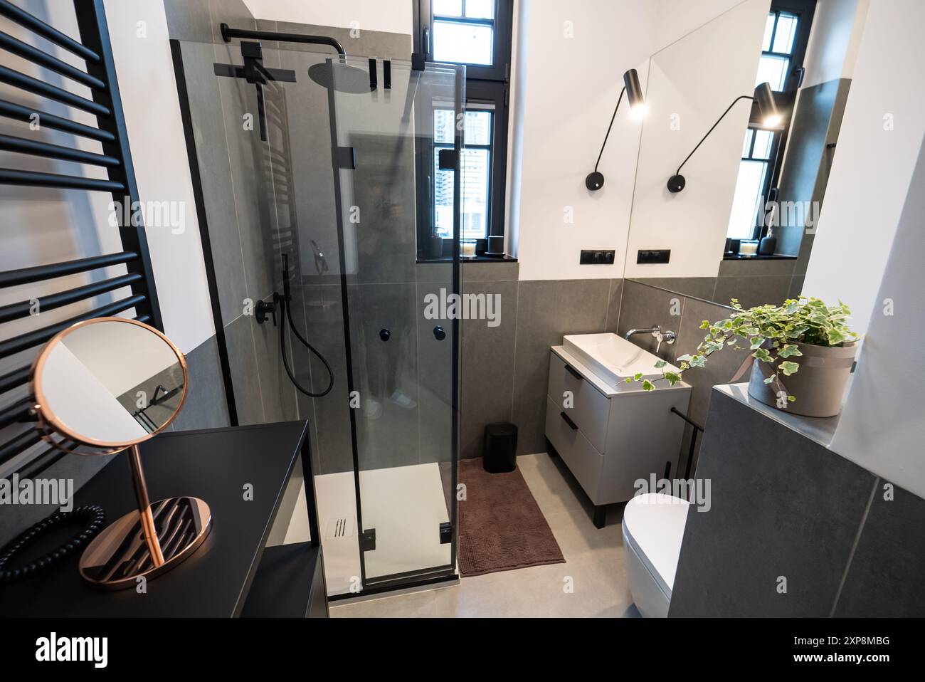 Interior of a modern bathroom featuring sleek tile walls and concrete ...