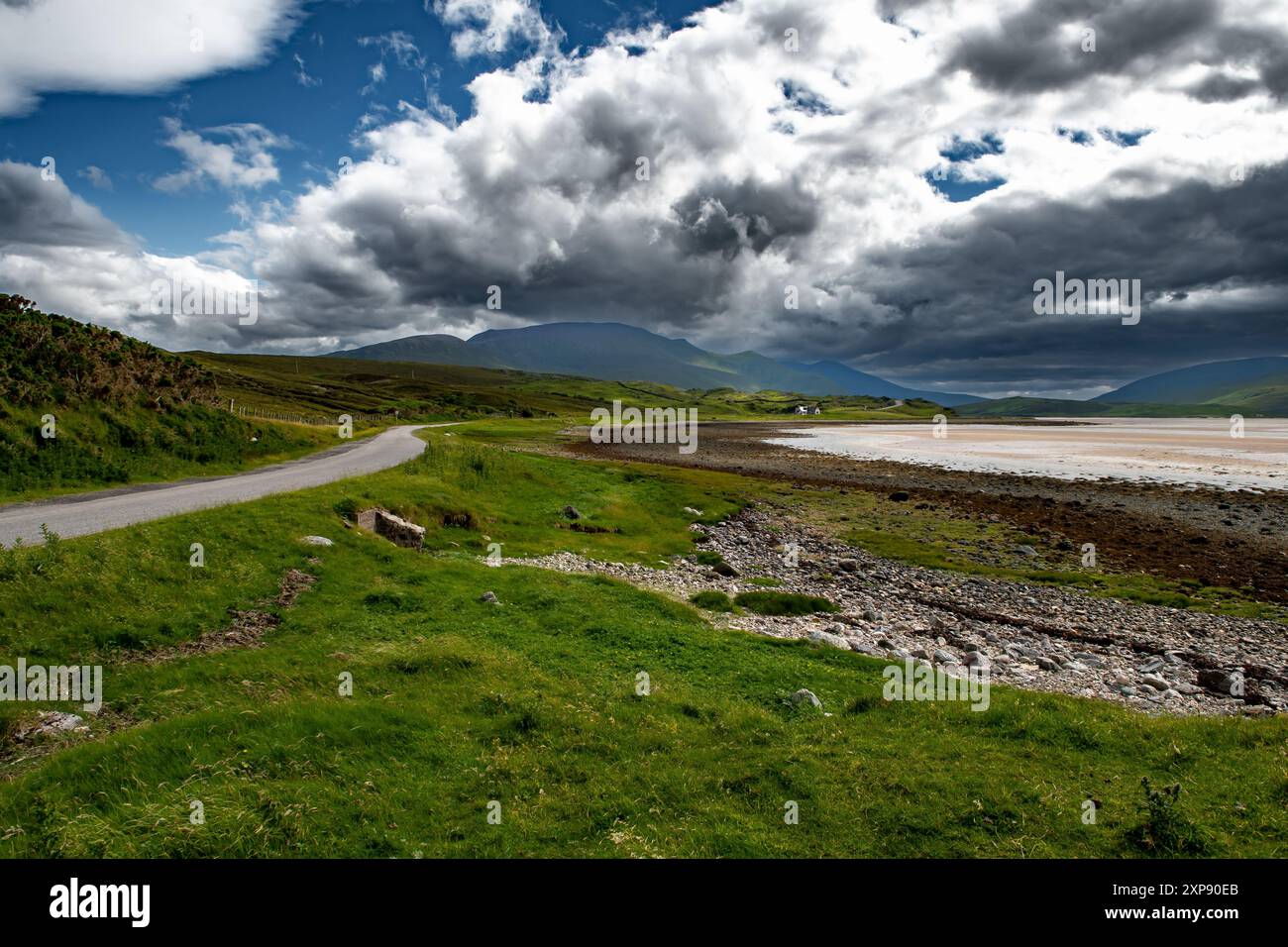 Abandoned Single Lane Road With Small Cottage And Mountains At Kyle Of Durness At The Atlantic Coast Of Scotland, UK Stock Photo