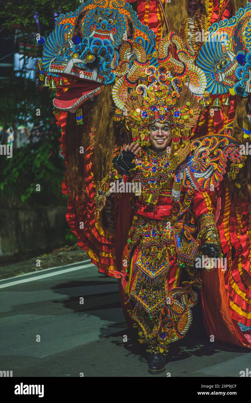 Balikpapan, Indonesia - June 5th, 2024. he walks down the street on a parade during the Indonesian cultural festival fashion show. Stock Photo
