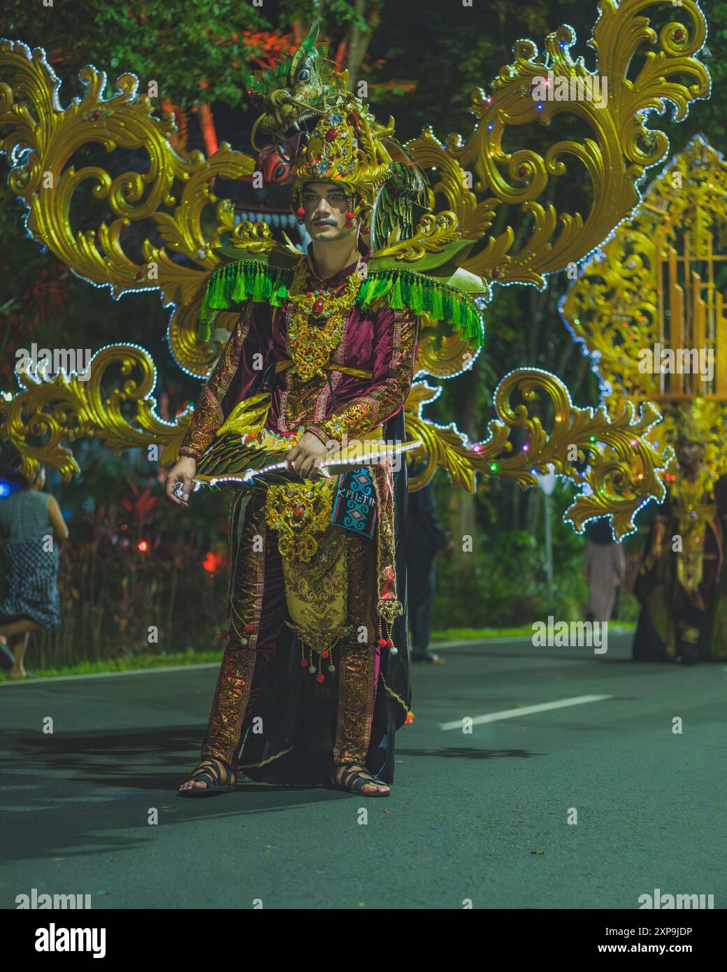 Balikpapan, Indonesia - June 5th, 2024. he walks down the street on a parade during the Indonesian cultural festival fashion show. Stock Photo