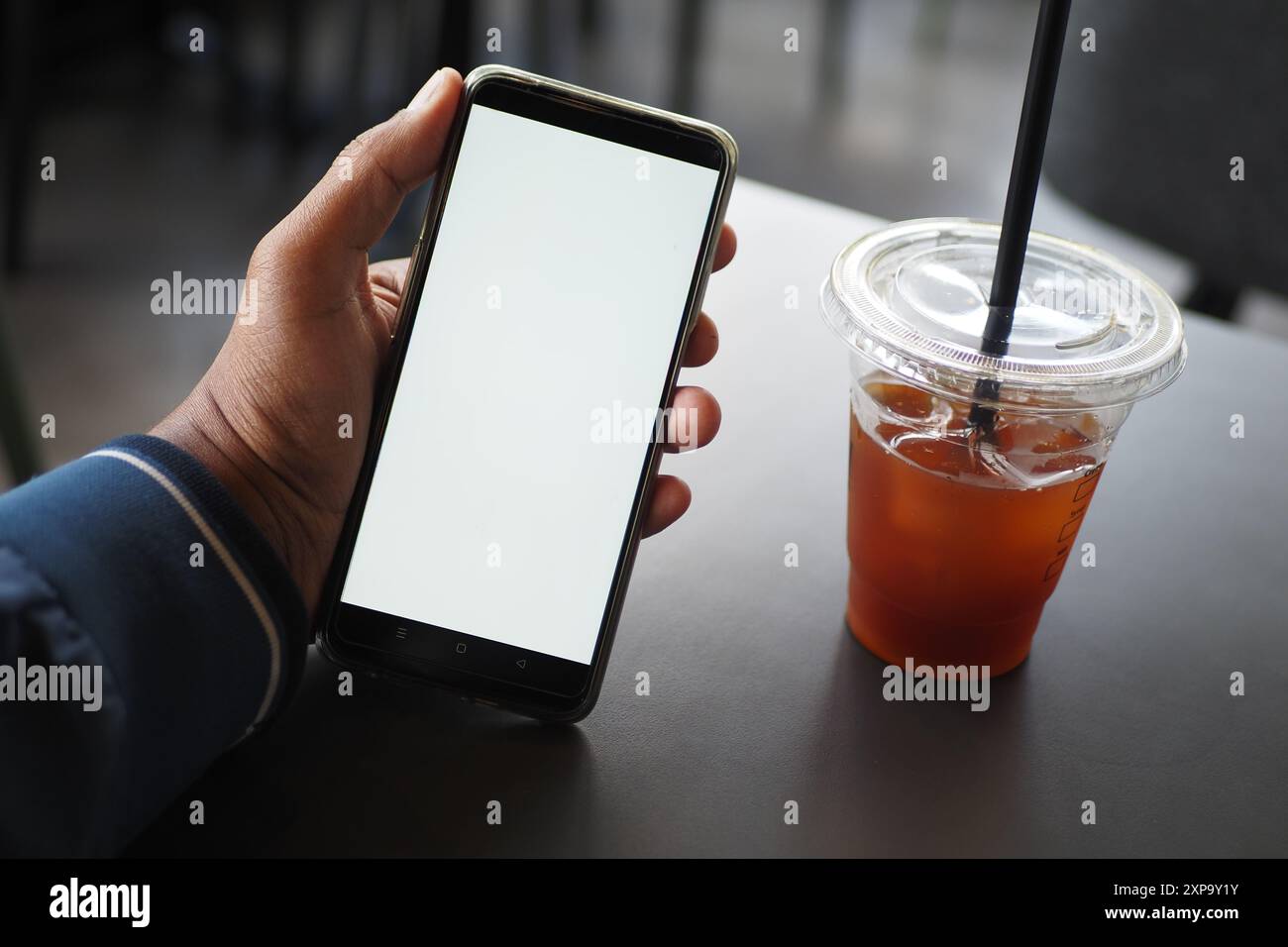 young man hand using smart phone with green screen at cafe Stock Photo ...