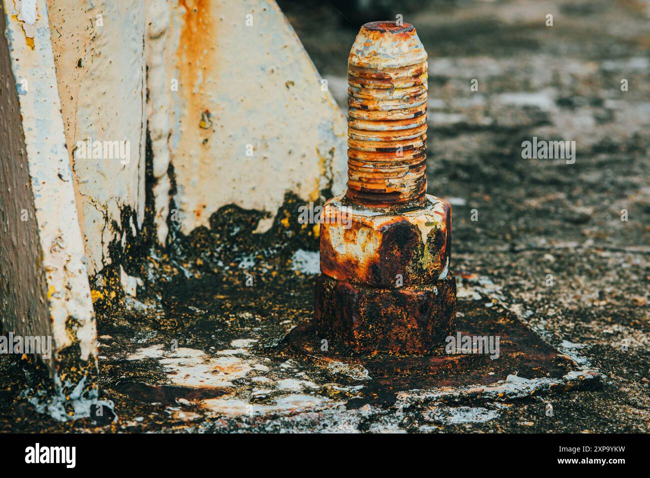 Rusty bolts holding a metal construction are showing corrosion, a ...
