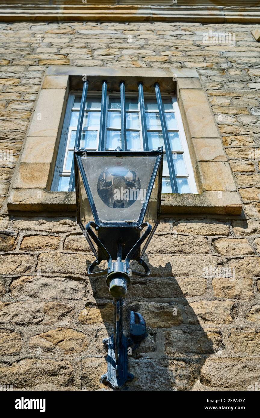 Lamp and barred window on Lancaster Maritime Museum wall occupying the former Custom house Stock Photo