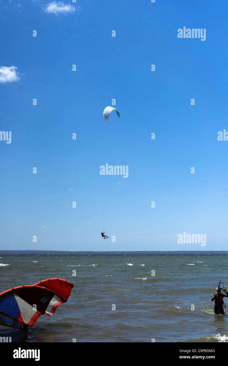 Man do tricks with his board practicising kitesurf jump in the air ...
