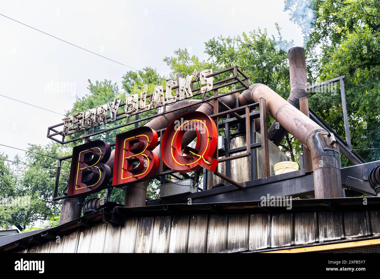 Smoke pipes and neon sign at Terry Black's BBQ, Austin, Texas Stock Photo