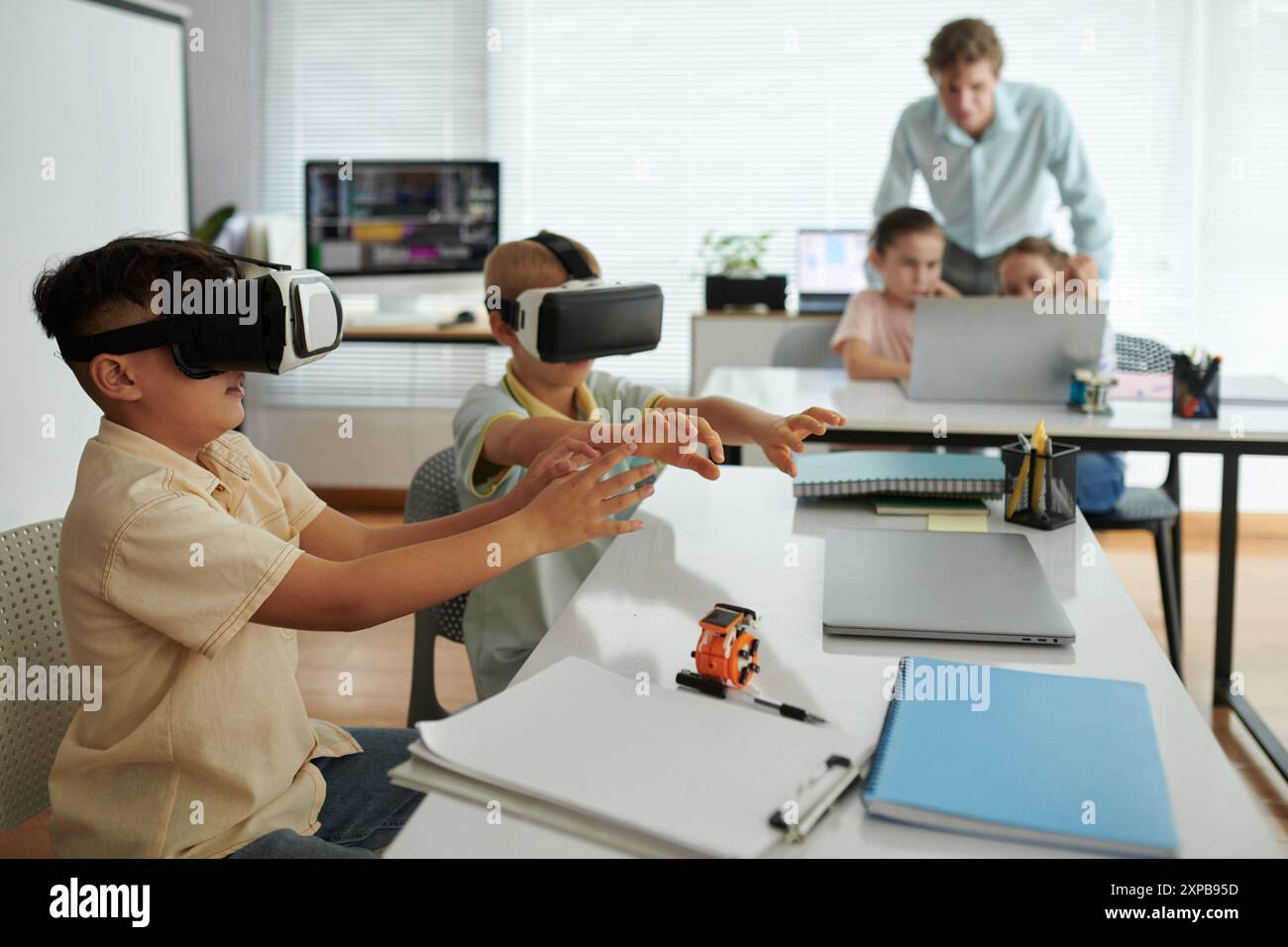 Children Experiencing Virtual Reality in Modern Classroom Stock Photo