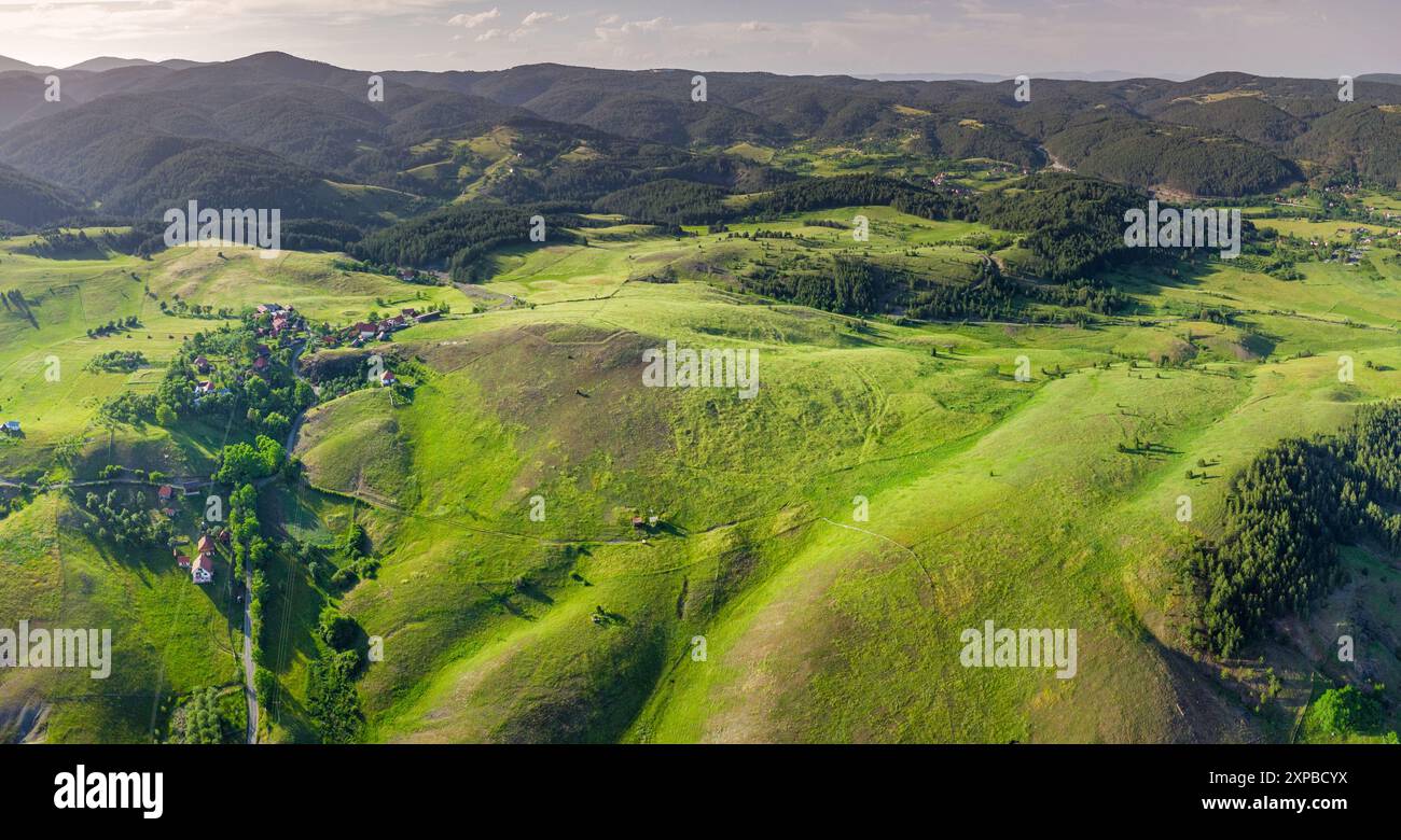 Aerial view of a green hill landscape with fields and forests in the ...