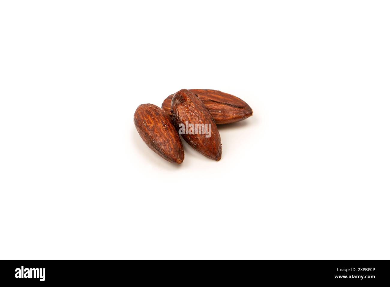 A group of caramelized almonds isolated on a white background. Stock Photo