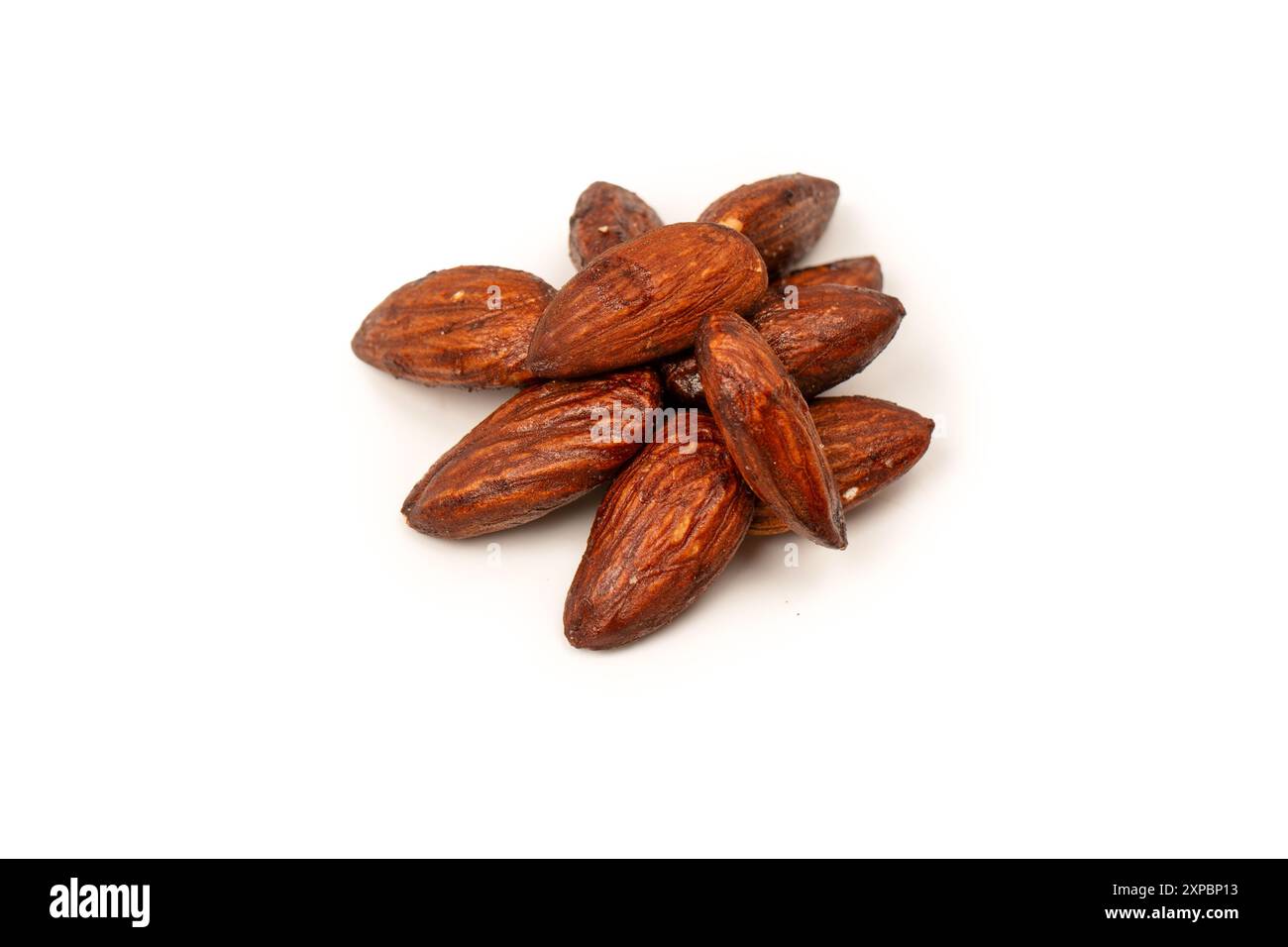 A group of caramelized almonds isolated on a white background. Stock Photo