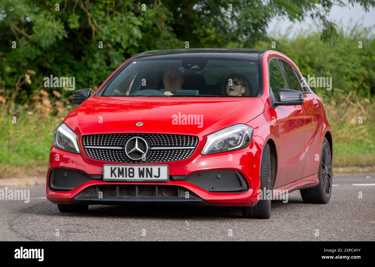 Whittlebury,Norhants,UK - Aug 4th 2024. Red 2018 Mercedes Benz A class A 200 AMG line car driving on a British country road Stock Photo