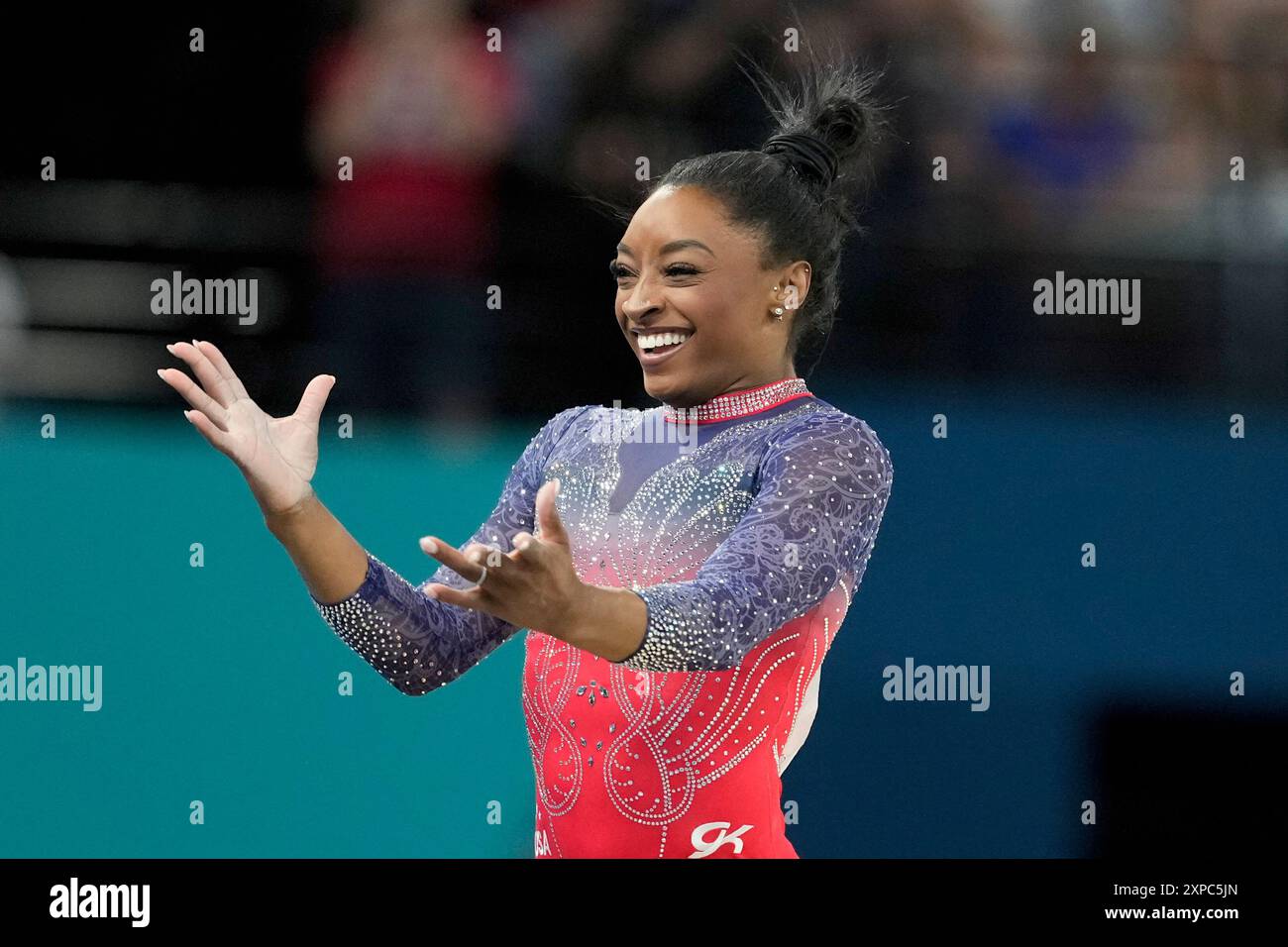 Simone Biles, of the United States, celebrates after completing her ...