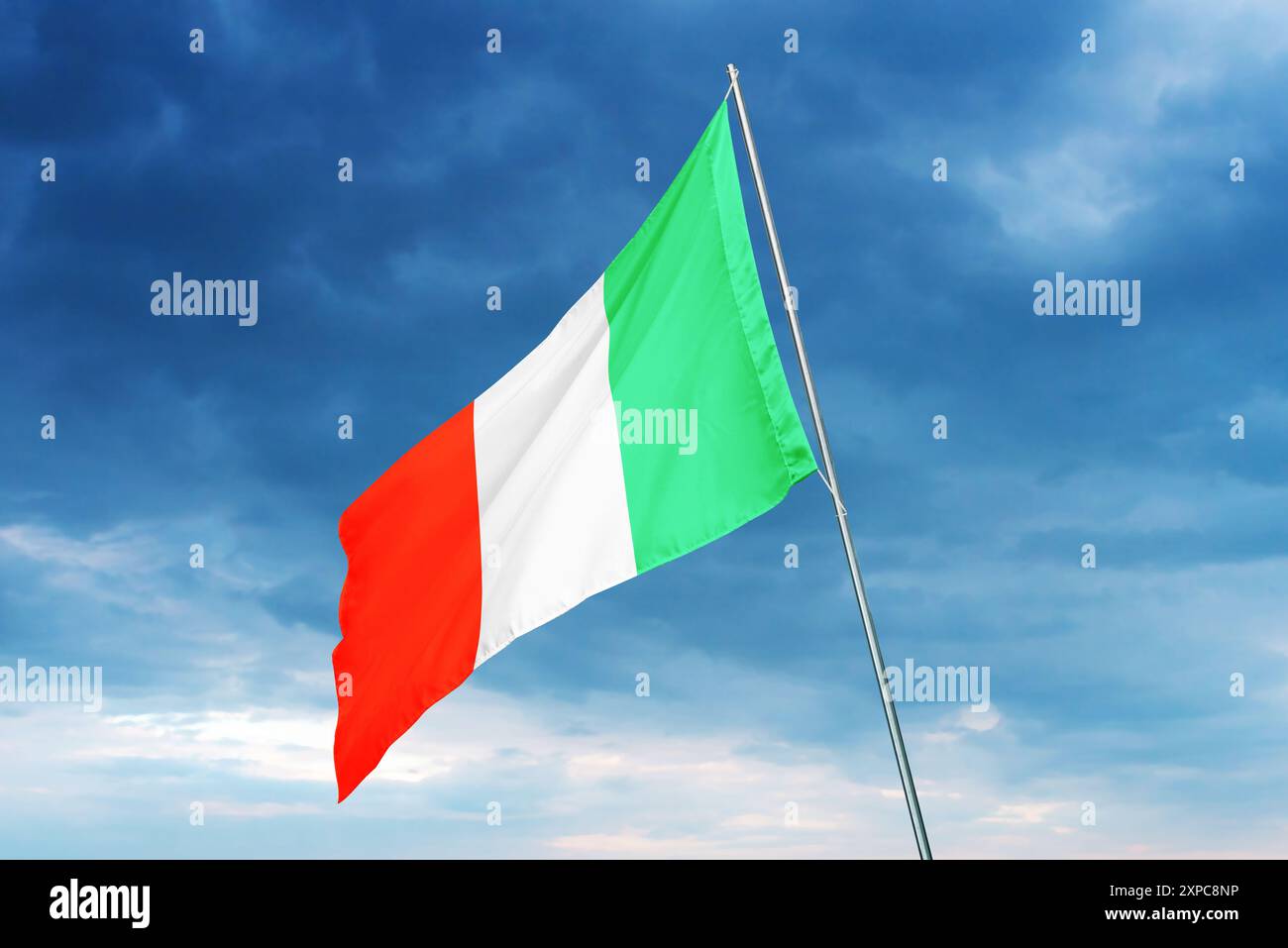 Italian flag waving gracefully, symbolizing national pride and unity. The flag’s distinct green, white, and red colors highlight Italy's rich heritage Stock Photo