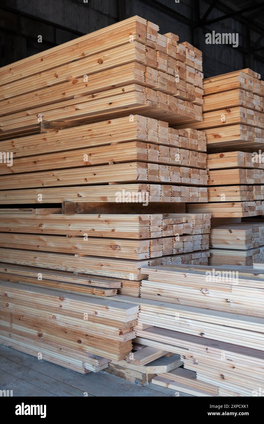 Stacked wooden planks close-up at lumber warehouse. Wood industry ...
