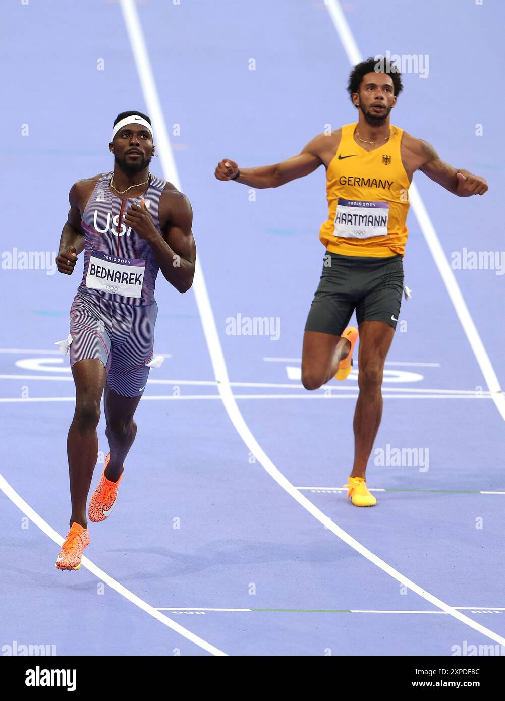 Paris, France. 5th Aug, 2024. Kenneth Bednarek (L) of the United States and Joshua Hartmann of Germany compete during the men's 200m round 1 of Athletics at the Paris 2024 Olympic Games in Paris, France, Aug. 5, 2024. Credit: Li Ying/Xinhua/Alamy Live News Stock Photo