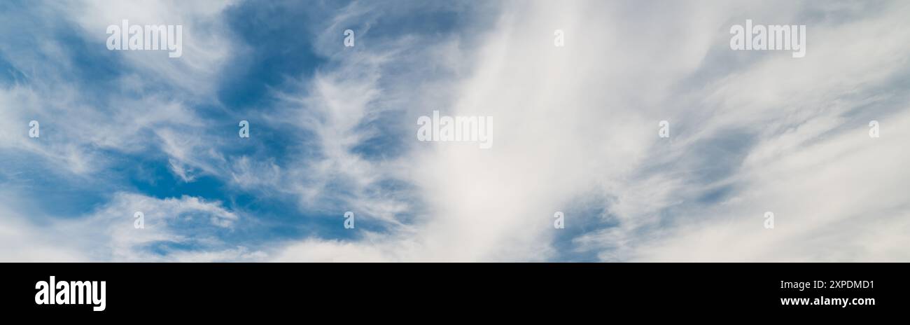 Blue sky between white clouds. Sky background texture Stock Photo