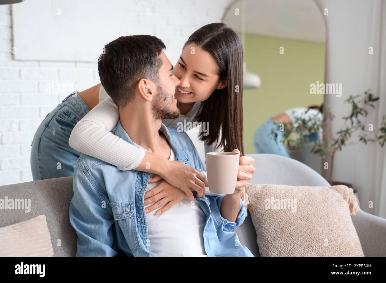 Young woman hugging her beloved boyfriend at home Stock Photo - Alamy