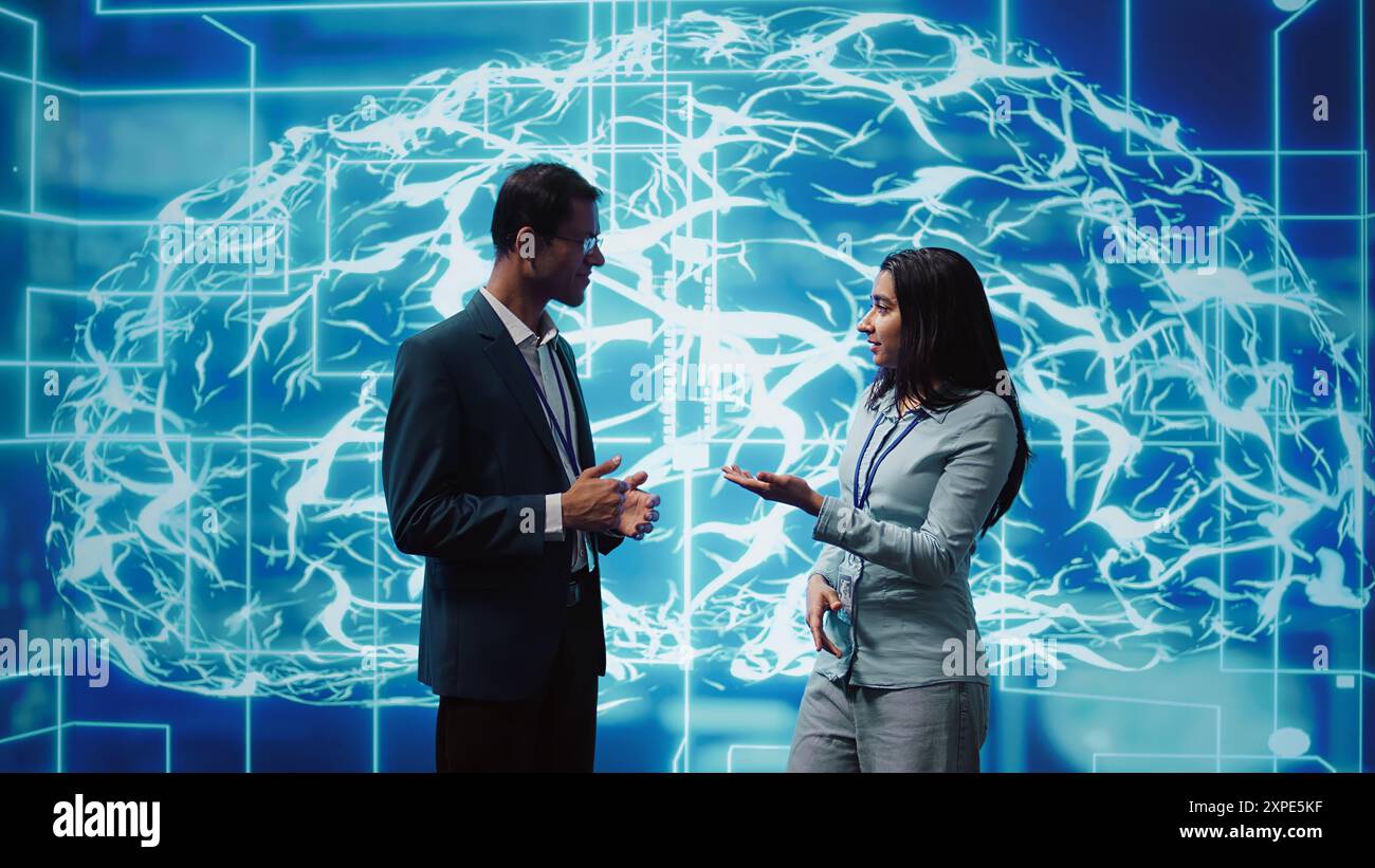 Computer scientists use AI neural networks modeled after human brain to solve complex problems. Startup employees using artificial intelligence to look at data and complete tasks, camera B Stock Photo