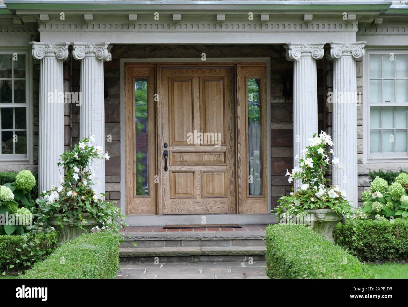 Wood grain front door of house with classical style columns Stock Photo ...