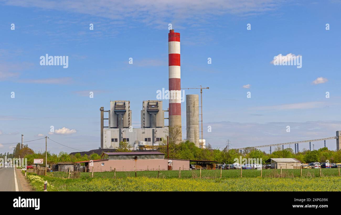 Obrenovac, Serbia - April 04, 2024: Red and White Chimney at Thermal Power Plant Facility Spring Day. Stock Photo