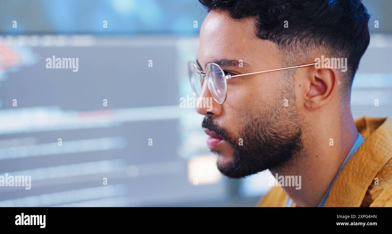 Serious, man and coding with computer for cybersecurity, developer update and app upgrade. Thinking, working and coder tech with programmer search and Stock Photo