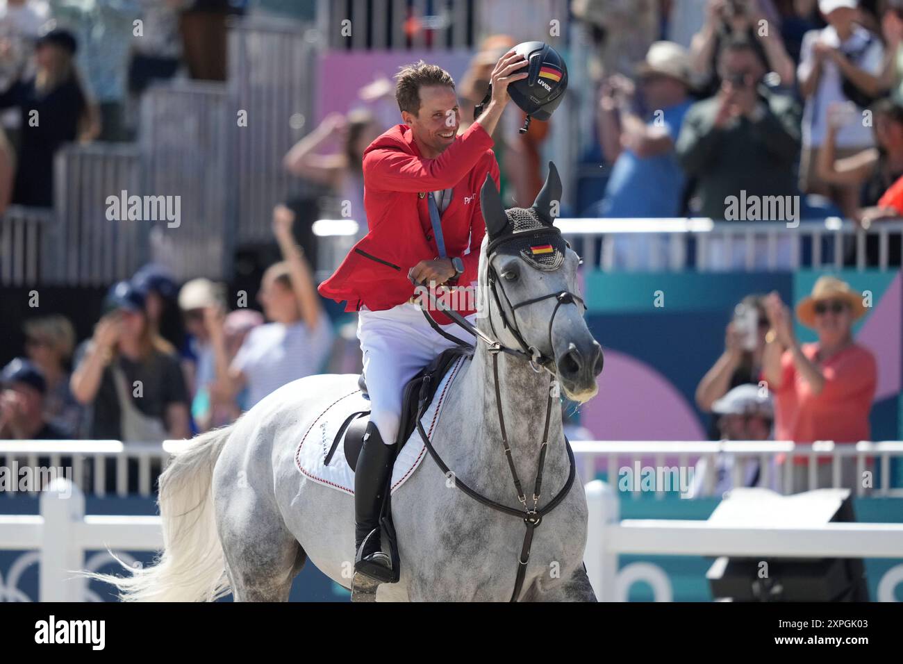 Germany's Christian Kukuk wearing his gold medal rides Checker 47 after ...