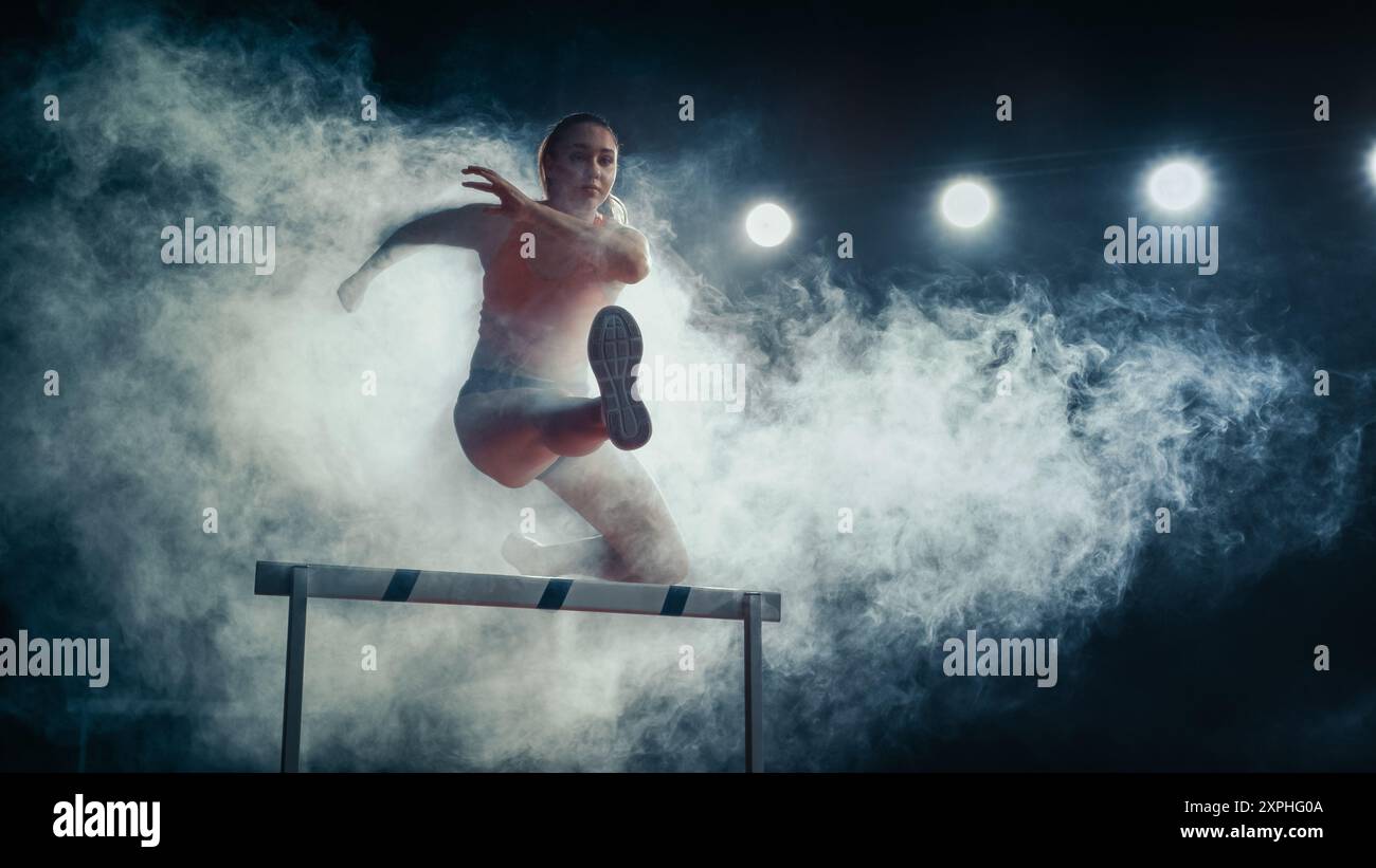 Female Athlete Runner Jumping Over Hurdle Amidst Dramatic Smoke and ...