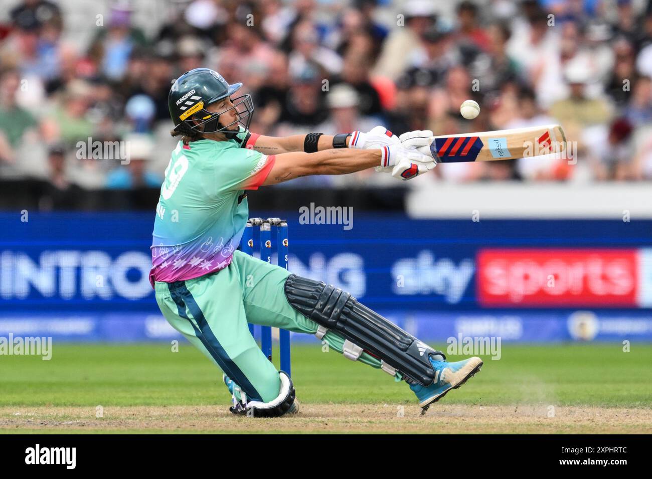 Tom Curran of Oval Invincibles hits a four (4) as he slips during the ...
