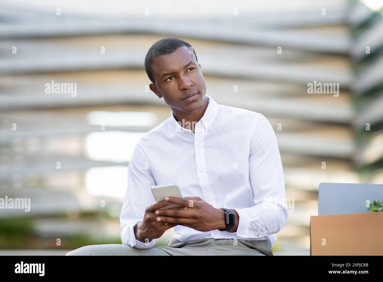 Young Professional Engaged in Communication While Sitting in Modern Area Stock Photo
