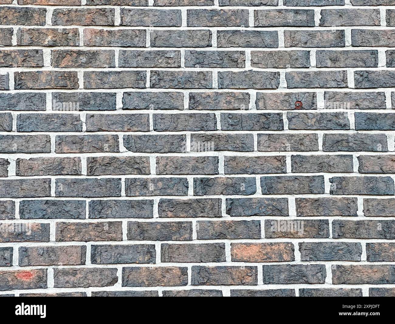 Close-up of grey brick wall showcasing the uniform pattern and texture