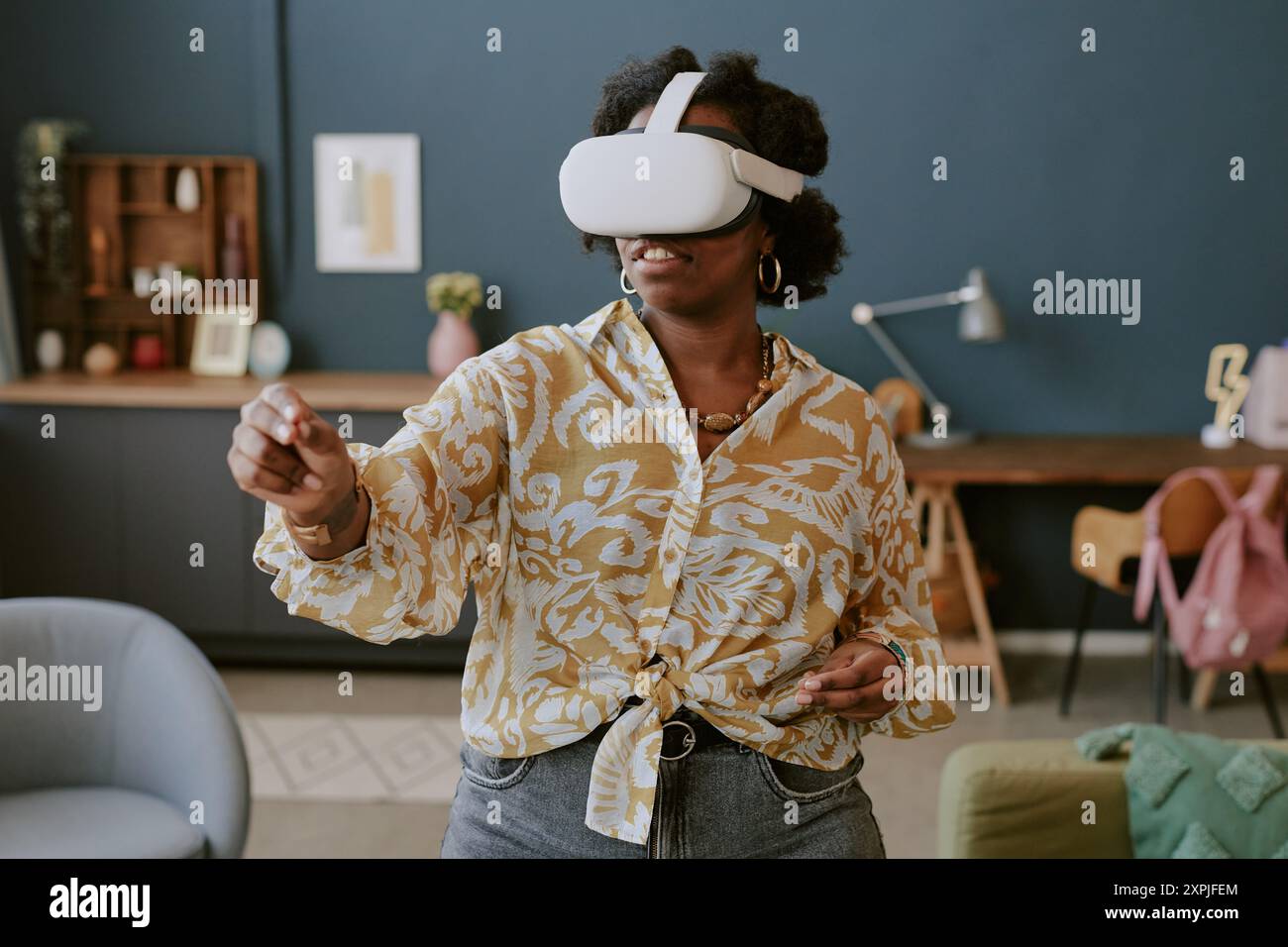 Using Virtual Reality Headset in Modern Living Room Stock Photo
