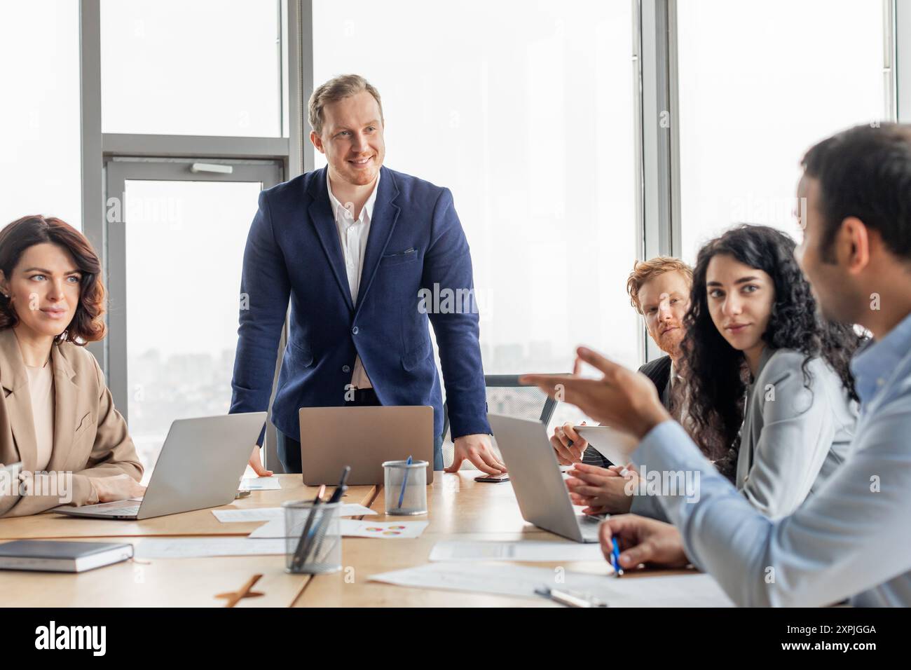 Business Professionals Discussing Ideas in Modern Office Setting Stock Photo