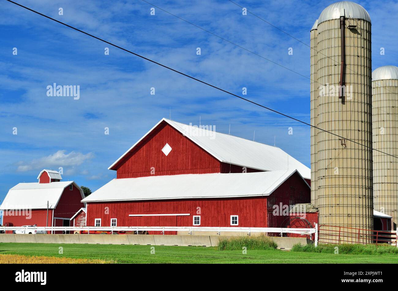 Cortland, Illinois, USA. A cluster of bright red barns and sheds basking in the afternoon sun in rural, agricultural Illinois. Stock Photo