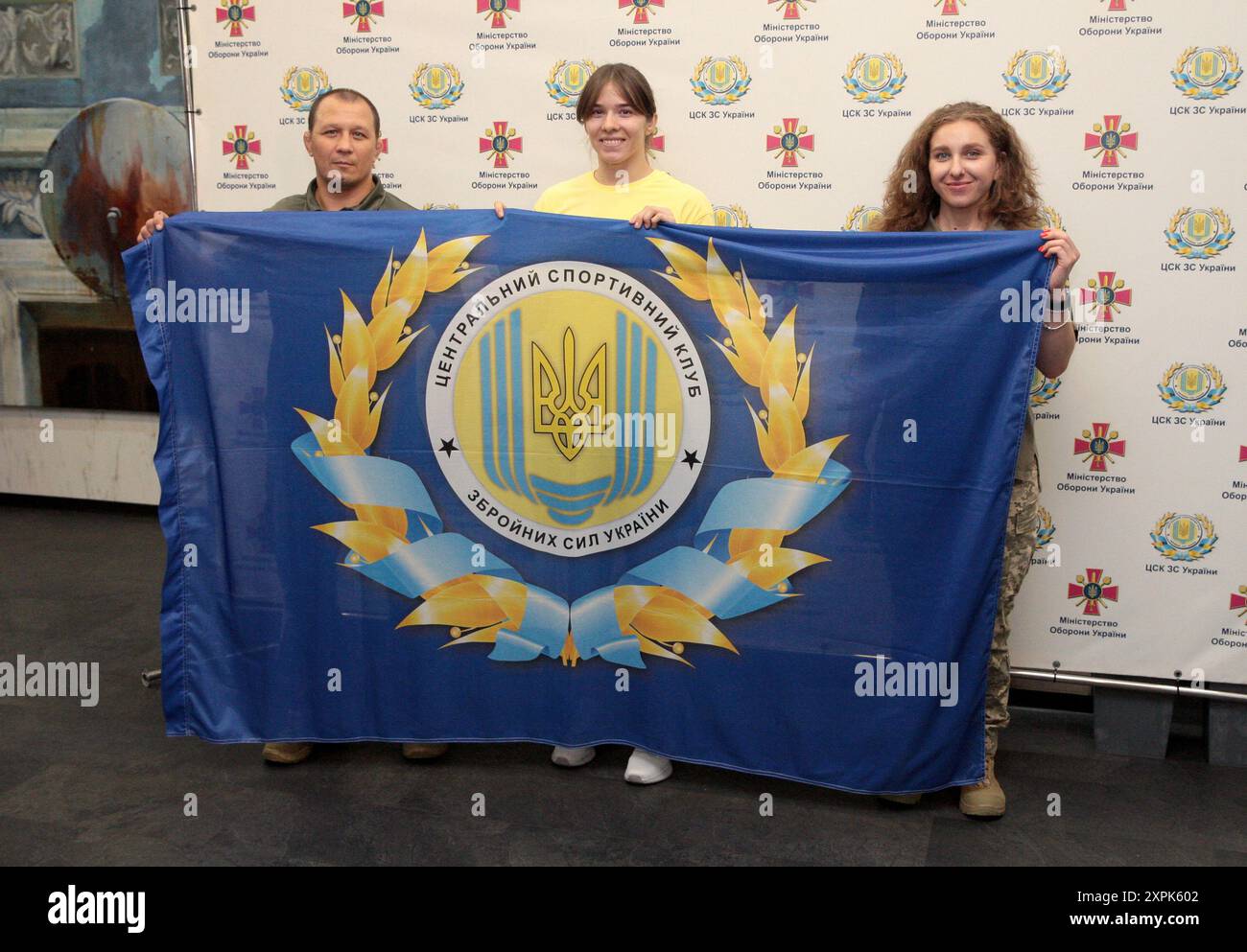 Non Exclusive: KYIV, UKRAINE - AUGUST 2, 2024 - Ukrainian freestyle wrestler Tetiana Sova (C) poses for a photo with the banner of the Central Sports Stock Photo