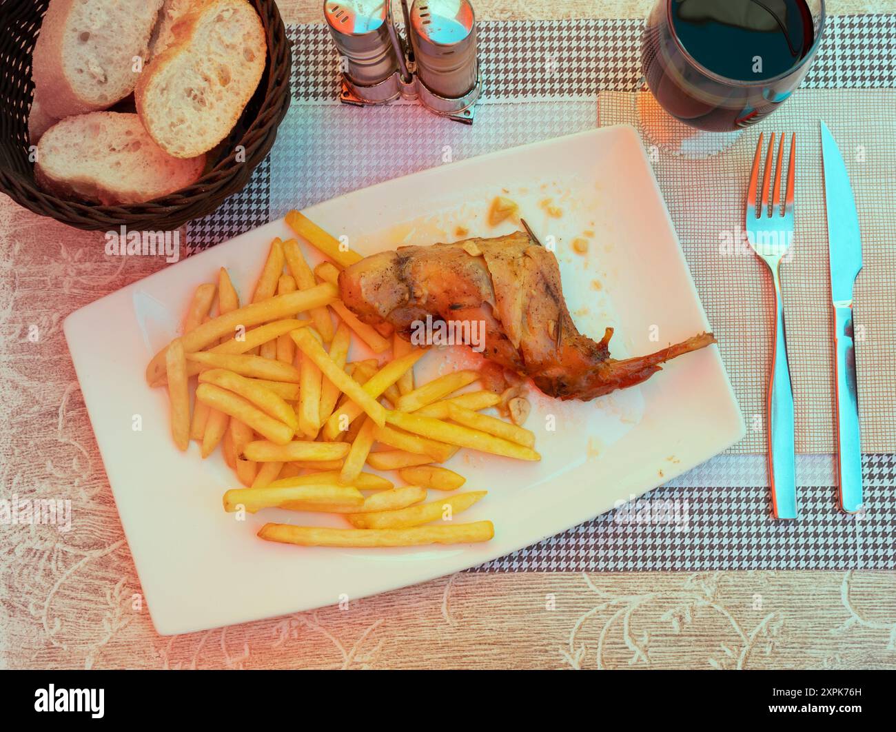 Braised rabbit served with potato garnish Stock Photo
