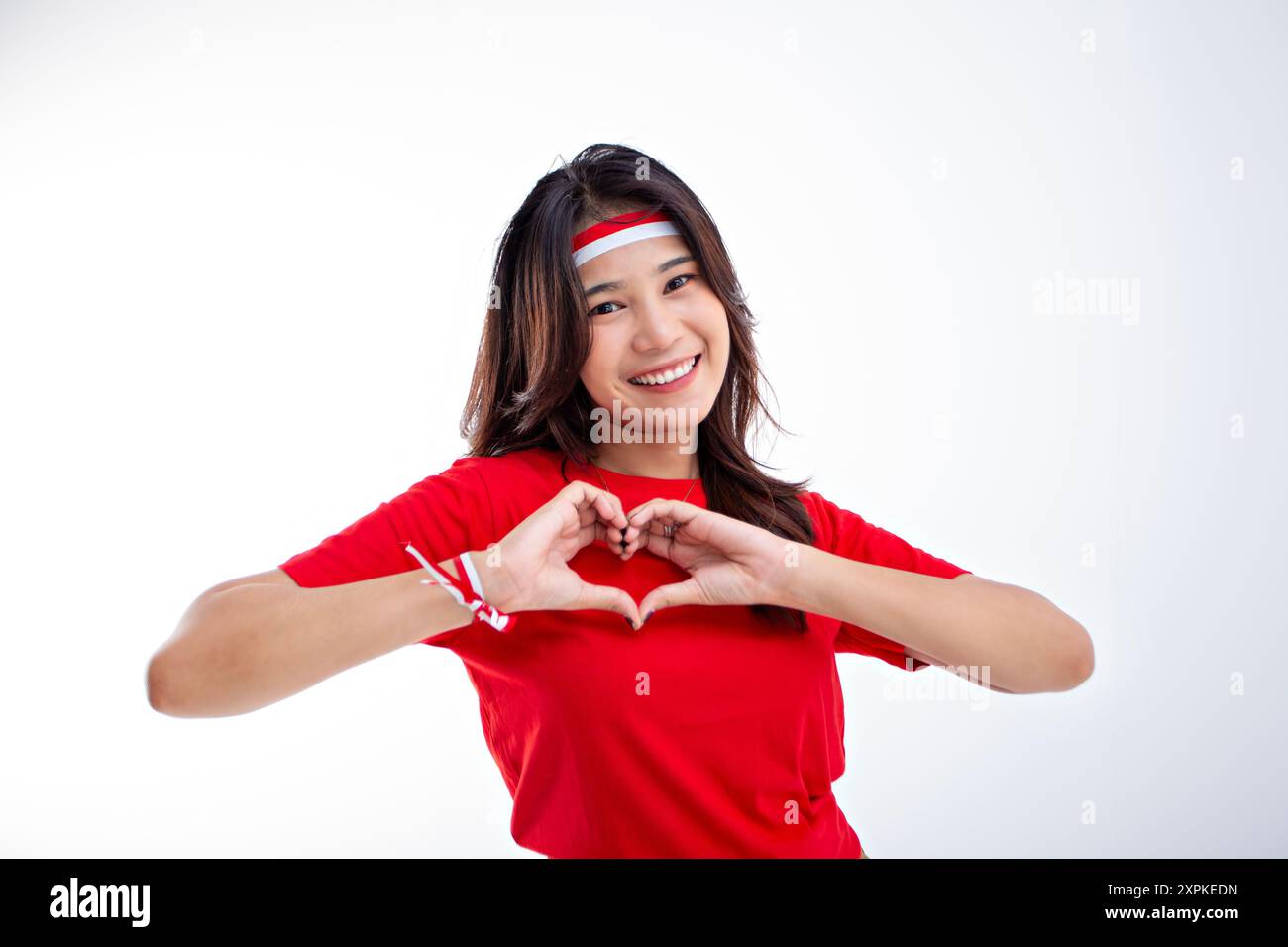 beautiful girl in red giving affection to her chest while smiling ...