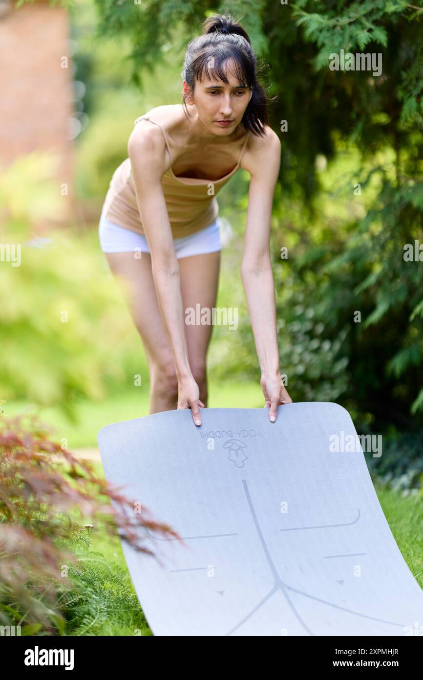 Woman practicing Yoga outdoors Stock Photo